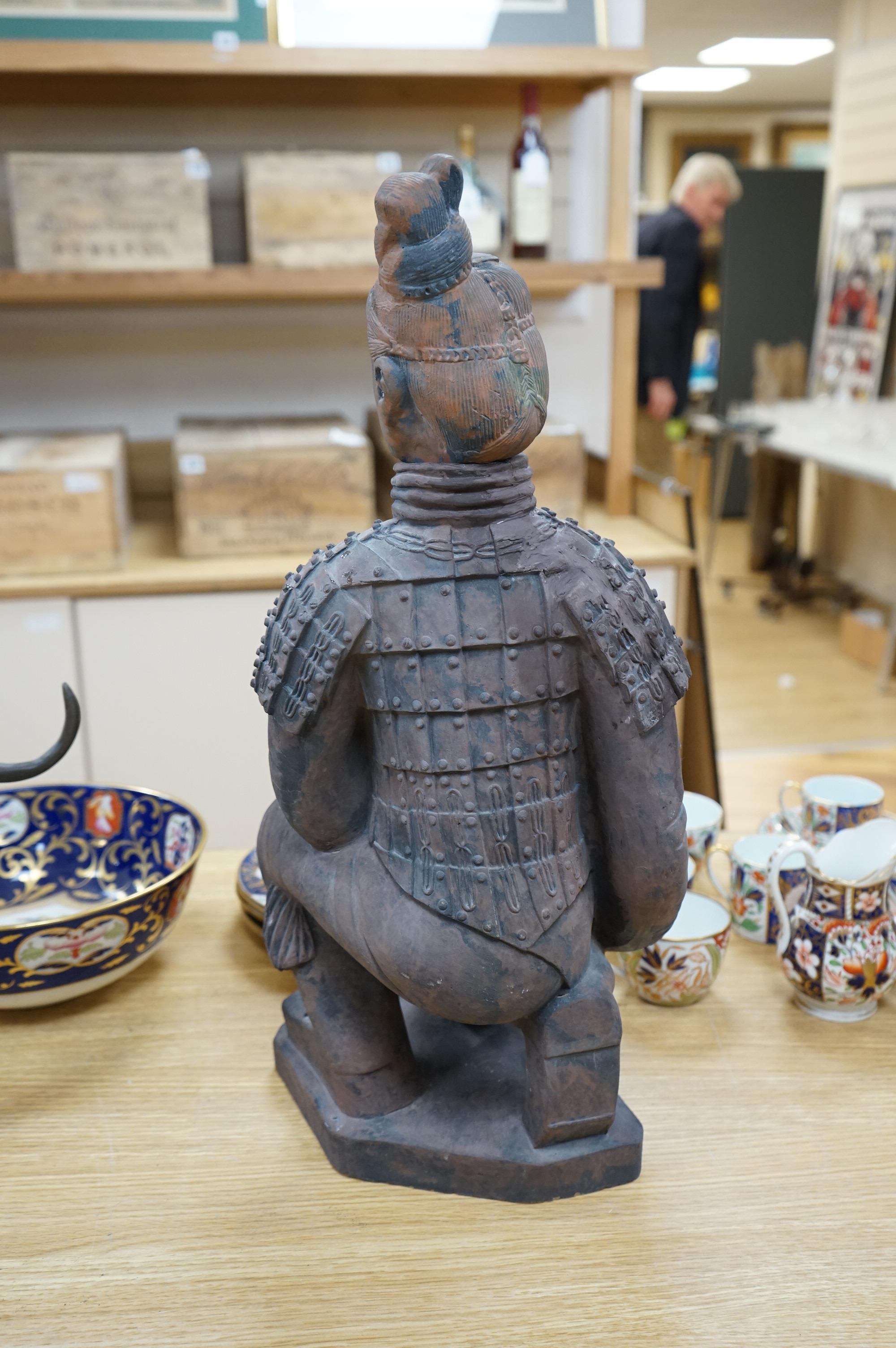 A large Chinese pottery figure of a kneeling warrior/soldier, 53cm high. Condition - good